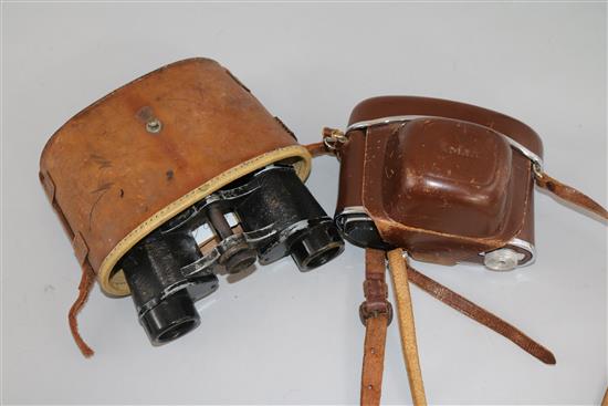 A pair of cased military binoculars and a camera